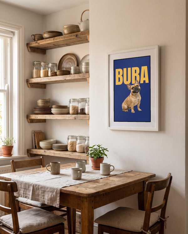 Framed pet name poster on a kitchen wall with open shelves