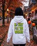 Person seen from behind in the white No Rest For The Wicked hoodie