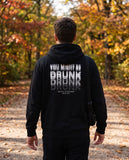 Person wearing the black You Might Be Drunk hoodie, seen from behind