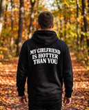 Person wearing the black My Girlfriend Is Hotter Than You hoodie, seen from behind