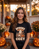 Person wearing the black Spooky But Make It Cozy t-shirt
