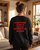 Person wearing the black Everything I Love Is Illegal Expensive Or Blonde crewneck sweatshirt, seen from behind