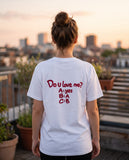 Person wearing the white Do U Love Me t-shirt, seen from behind