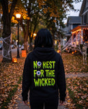 Person seen from behind in the black No Rest For The Wicked hoodie
