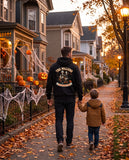 Dad seen from behind in a black hoodie with the custom family Halloween portrait on the back