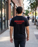 Person wearing the black Undiagnosed But Something Ain't Right t-shirt, seen from behind