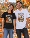 Couple at a pumpkin patch wearing the black and white Haunted By My Own Decisions tees