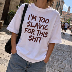 White I'm too Slavic for this shit printed T-shirt worn on an old town street