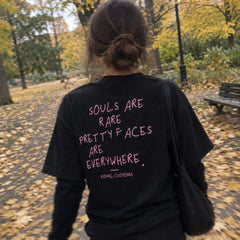 Black T-shirt with pink Souls are rare back print on an autumn park walk
