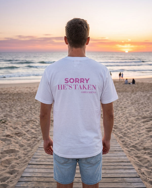 Man seen from behind wearing the white Sorry He's Taken t-shirt