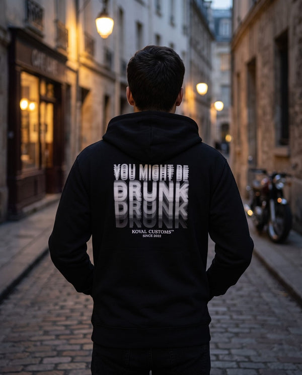 Person wearing the black You Might Be Drunk zip hoodie, seen from behind