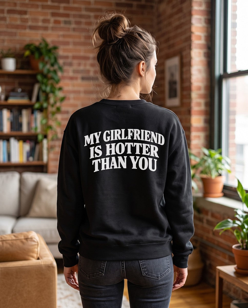 Person wearing the black My Girlfriend Is Hotter Than You crewneck sweatshirt, seen from behind