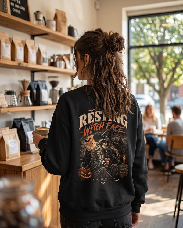 Person wearing the black Resting Witch Face crewneck sweatshirt, seen from behind