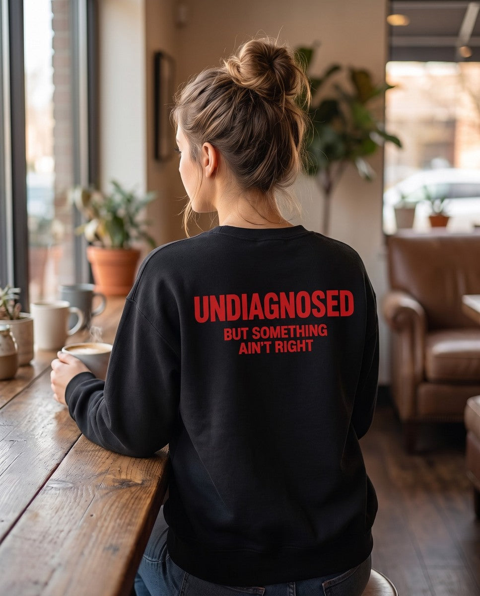Person wearing the black Undiagnosed But Something Ain't Right crewneck sweatshirt, seen from behind