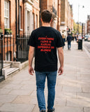Person wearing the black Everything I Love Is Illegal Expensive Or Blonde t-shirt, seen from behind