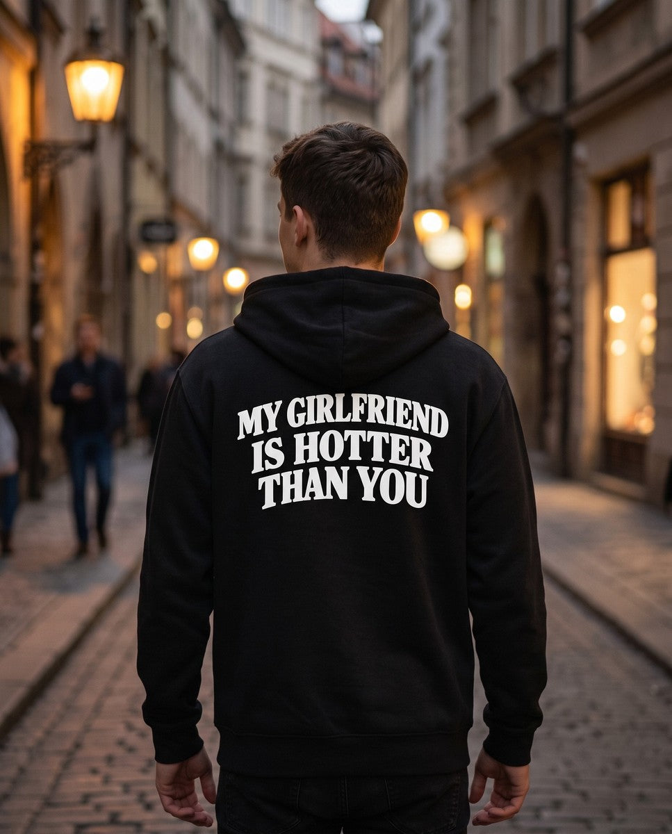 Person wearing the black My Girlfriend Is Hotter Than You zip hoodie, seen from behind