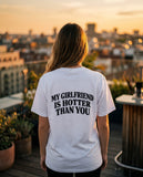 Person wearing the white My Girlfriend Is Hotter Than You t-shirt, seen from behind