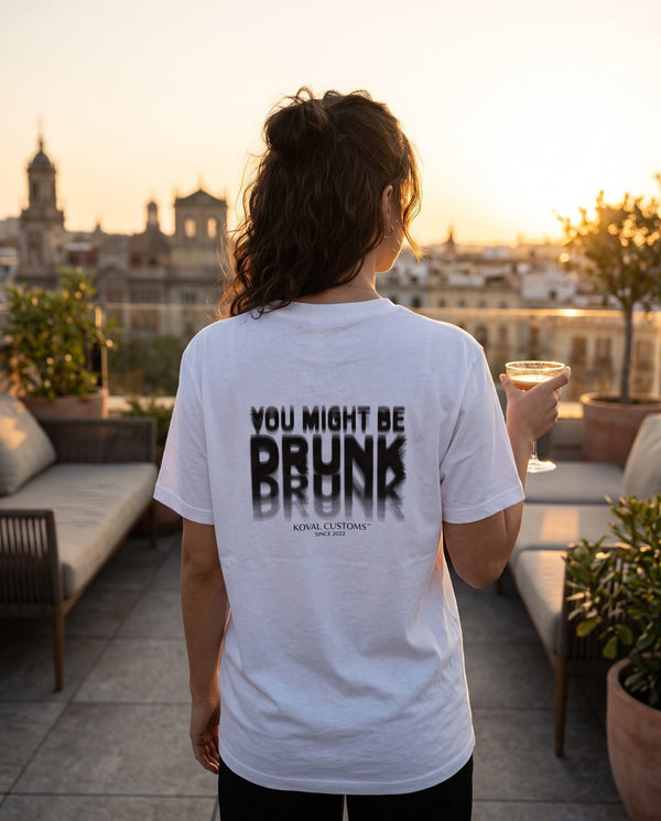Person wearing the white You Might Be Drunk t-shirt, seen from behind