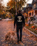 Man walking his dog in a black hoodie with the custom dog portrait on the back