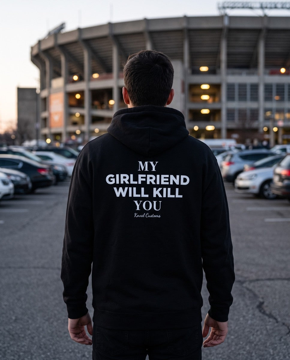 Man seen from behind wearing the black My Girlfriend Will Kill You hoodie