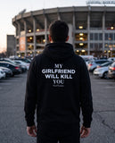 Man seen from behind wearing the black My Girlfriend Will Kill You hoodie