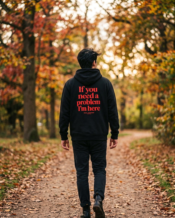 Person wearing the black If You Need A Problem I'm Here hoodie, seen from behind