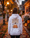 Person seen from behind in the white Too Cute To Spook hoodie