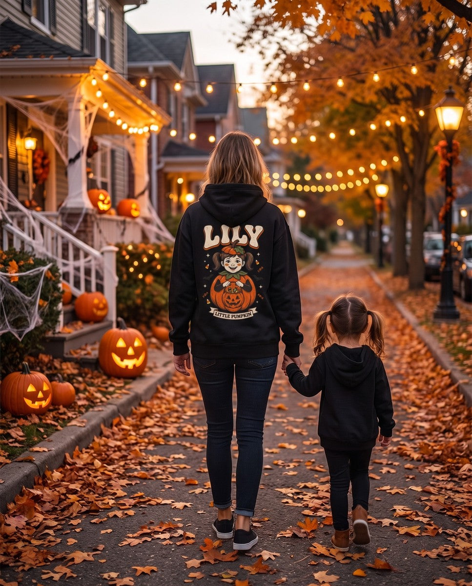 Mom seen from behind in a black hoodie with her child's Halloween portrait on the back