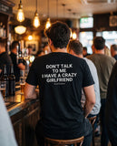 Man seen from behind wearing the black Don't Talk To Me I Have A Crazy Girlfriend t-shirt