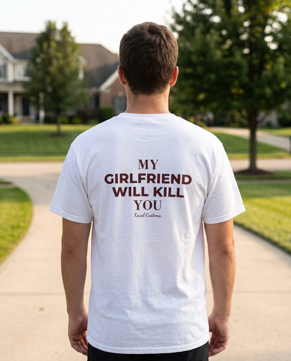 Man seen from behind wearing the white My Girlfriend Will Kill You t-shirt