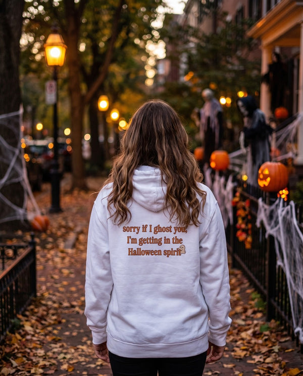 Person seen from behind in the white Sorry If I Ghost You hoodie
