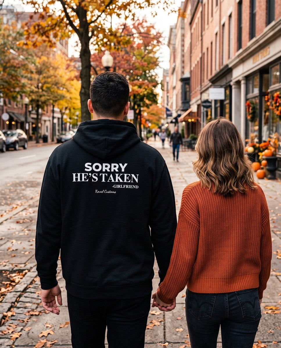 Man seen from behind wearing the black Sorry He's Taken hoodie
