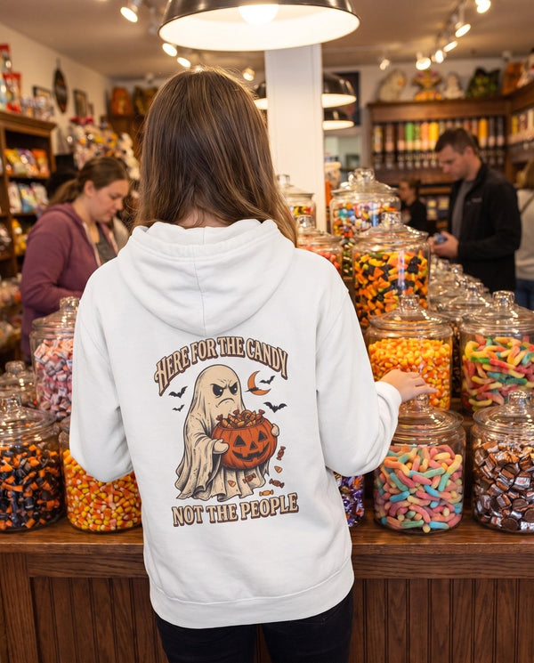 Person seen from behind in the white Here For The Candy Not The People hoodie