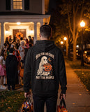 Person seen from behind in the black Here For The Candy Not The People hoodie