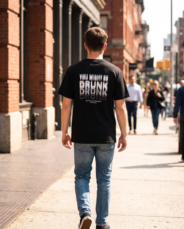 Person wearing the black You Might Be Drunk t-shirt, seen from behind