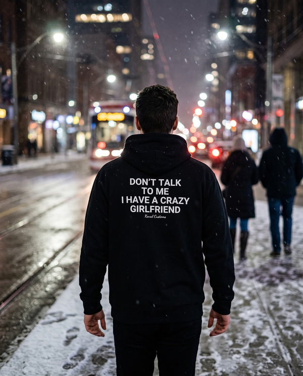 Man seen from behind wearing the black Don't Talk To Me I Have A Crazy Girlfriend hoodie