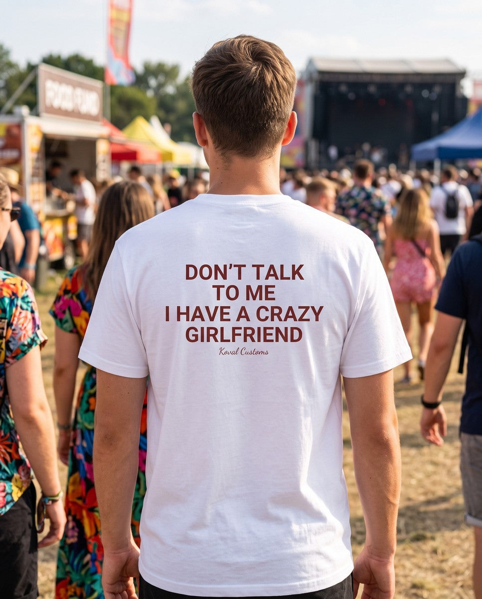 Man seen from behind wearing the white Don't Talk To Me I Have A Crazy Girlfriend t-shirt