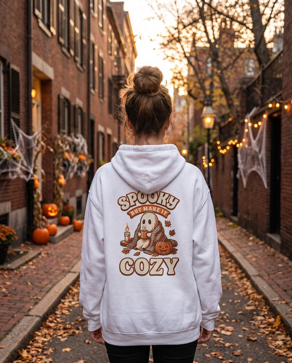 Person seen from behind in the white Spooky But Make It Cozy hoodie