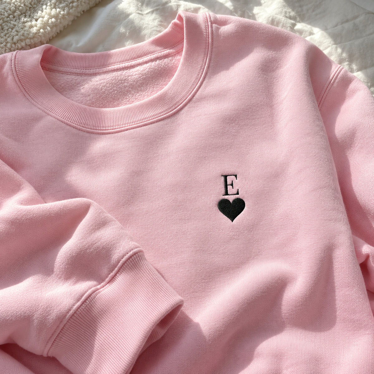 [US] Initial With Heart Embroidered Sweatshirt - pink crewneck sweatshirt laid flat
