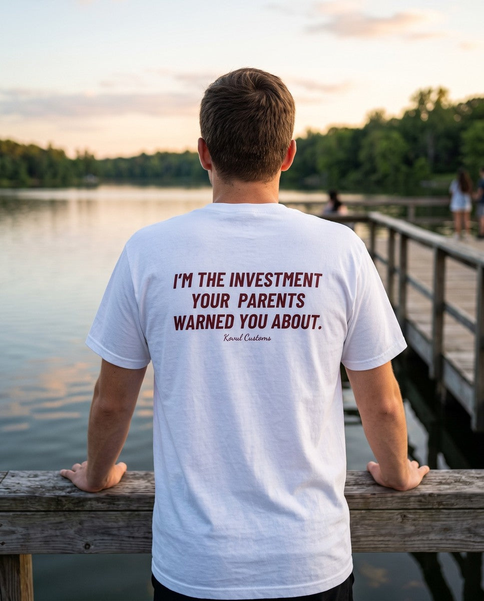 Man seen from behind wearing the white I'm The Investment Your Parents Warned You About t-shirt
