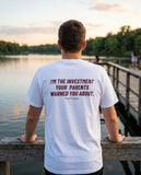 Man seen from behind wearing the white I'm The Investment Your Parents Warned You About t-shirt