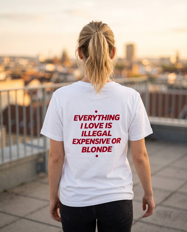 Person wearing the white Everything I Love Is Illegal Expensive Or Blonde t-shirt, seen from behind