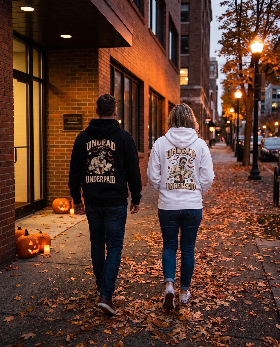 Two friends seen from behind in the black and white Undead And Underpaid hoodies
