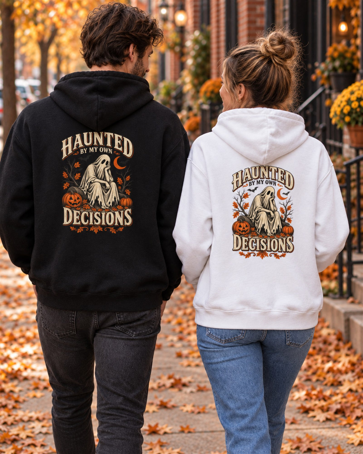 Couple walking down an autumn street in the black and white Haunted By My Own Decisions hoodies, back print