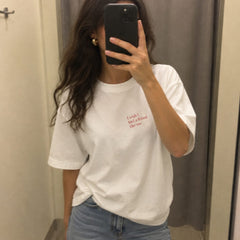 Mirror selfie in a white T-shirt with small I wish I had a friend like me text