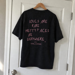 Black Souls are rare, pretty faces are everywhere T-shirt on a hanger, back print