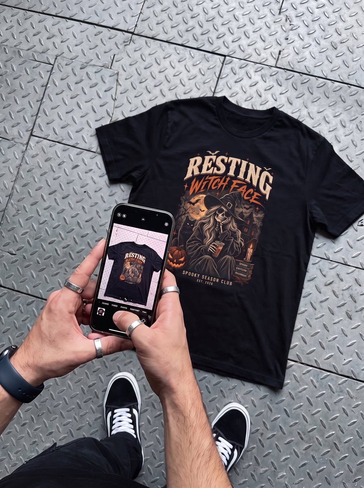 Black Resting Witch Face t-shirt flat-lay photographed on a phone