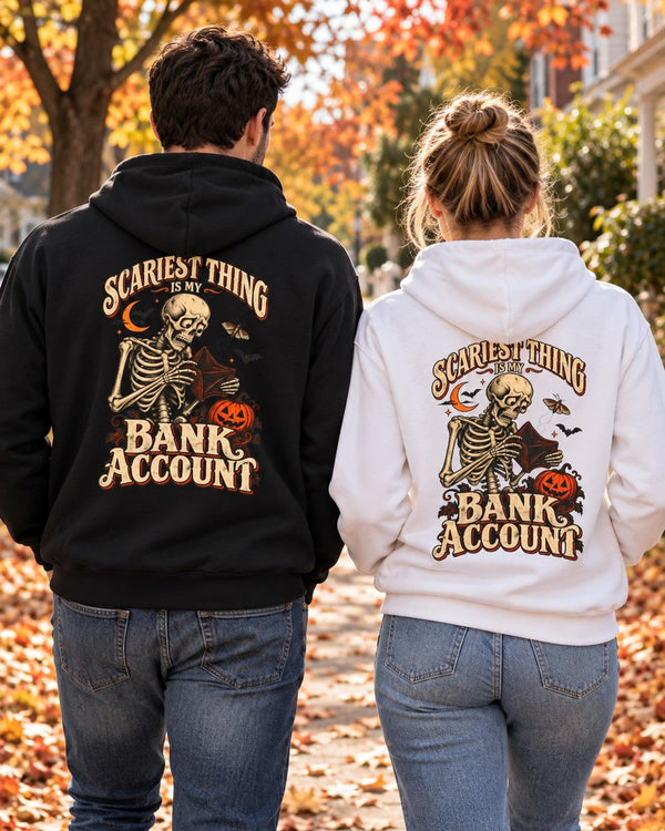 Couple walking down an autumn street in the black and white Scariest Thing Is My Bank Account hoodies, back print